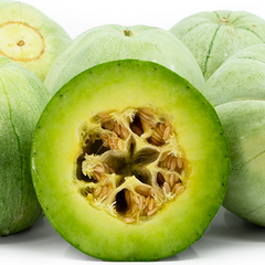 Green melon with a cut half showing its interior on a white background