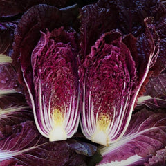 Close-up of a purple cabbage cut in half, revealing its inner layers.
