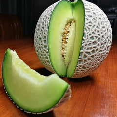 Melon with a slice cut out on a wooden table
