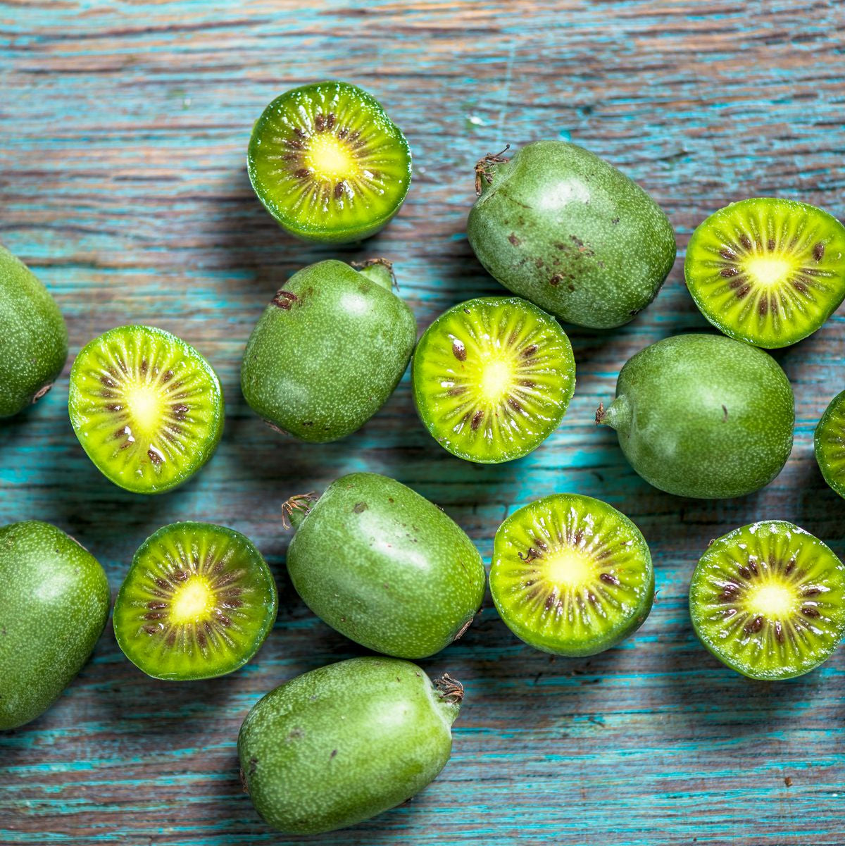 Green kiwis on a wooden surface