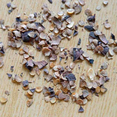 Small stones or pebbles scattered on a wooden surface