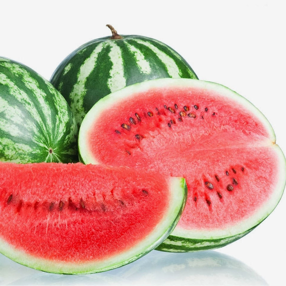 Whole and sliced watermelons on a reflective surface with a white background
