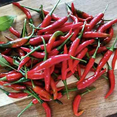 Red chili peppers on a wooden cutting board